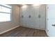 Bedroom with a wall of built-in storage cabinets, wood-look tile floor, and a window at 3139 Marine Grass Dr, Wimauma, FL 33598