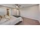 Large bedroom features neutral carpeting, ceiling fan, and ensuite bathroom access at 3139 Marine Grass Dr, Wimauma, FL 33598