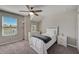 Bright bedroom with a ceiling fan, large window, and neutral decor provides a comfortable and inviting space at 3139 Marine Grass Dr, Wimauma, FL 33598