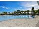 Resort-style swimming pool surrounded by lounge chairs and palm trees, offering a luxurious community experience at 3139 Marine Grass Dr, Wimauma, FL 33598