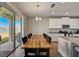 An open dining space features a wood table and sliding glass doors to a patio at 3139 Marine Grass Dr, Wimauma, FL 33598