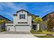 This two-story home has a three-car garage and is surrounded by beautiful landscaping at 3139 Marine Grass Dr, Wimauma, FL 33598