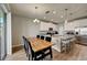 Eat-in kitchen showcasing granite counters, pendant lighting, stainless appliances, and island with bar stool seating at 3139 Marine Grass Dr, Wimauma, FL 33598