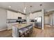 Modern kitchen features an island with seating, stainless steel appliances, and granite countertops at 3139 Marine Grass Dr, Wimauma, FL 33598