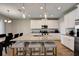 Open kitchen with island seating, stainless appliances, and access to the dining room at 3139 Marine Grass Dr, Wimauma, FL 33598