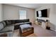 Comfortable living room features a large sectional sofa and entertainment center at 3139 Marine Grass Dr, Wimauma, FL 33598