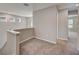 Upstairs loft area with carpet flooring and natural light from windows at 3139 Marine Grass Dr, Wimauma, FL 33598
