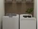 Laundry room featuring a modern washer and dryer with decorative accents at 32042 Spiceberry St, San Antonio, FL 33576