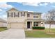 Charming two-story home features a two-car garage, neat landscaping, and shuttered windows at 35691 Jenny Lynne Cir, Zephyrhills, FL 33541