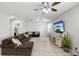 Inviting living room with a plush sectional sofa, entertainment center, and ceiling fans at 35691 Jenny Lynne Cir, Zephyrhills, FL 33541