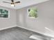 Bright bedroom featuring hardwood floors and natural light through large windows and ceiling fan at 3718 N 32Nd St, Tampa, FL 33610