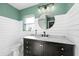 Stylish bathroom featuring a black vanity, marble countertop, and modern fixtures at 37420 Meridian Ave, Dade City, FL 33525