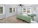 Bright bedroom featuring neutral carpet, a ceiling fan, and two windows providing outdoor views at 37420 Meridian Ave, Dade City, FL 33525