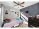 Bedroom with ceiling fan, complemented by decor, and natural light that fills the room at 37420 Meridian Ave, Dade City, FL 33525