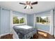 A peaceful bedroom with hardwood floors, natural light, and a comfortable bed at 37420 Meridian Ave, Dade City, FL 33525