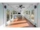 Covered patio with tile floor, multiple ceiling fans, and glass doors on each side at 37420 Meridian Ave, Dade City, FL 33525