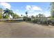 Long driveway leading to a modern home with basketball court, garage and landscaped yard in background at 37420 Meridian Ave, Dade City, FL 33525