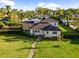 Beautiful home with well-manicured front lawn and mature trees creating a serene and inviting outdoor space at 37420 Meridian Ave, Dade City, FL 33525