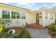 Charming home entrance with arched porch and brick steps at 37420 Meridian Ave, Dade City, FL 33525