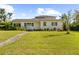 Inviting one-story home with manicured landscaping and a stone pathway at 37420 Meridian Ave, Dade City, FL 33525