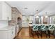 The kitchen features brick accents, marble counters and a large island for cooking and entertaining at 37420 Meridian Ave, Dade City, FL 33525