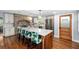 Stylish kitchen boasts a brick backsplash, island seating and stainless appliances creating a chef-inspired culinary space at 37420 Meridian Ave, Dade City, FL 33525