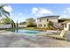 Inviting backyard swimming pool with brick patio, lounge chairs, and landscaped surroundings at 37420 Meridian Ave, Dade City, FL 33525