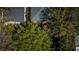 Overhead view of a home with a gray roof, deck, and tree-lined yard, creating a peaceful and private setting at 409 S Arrawana Ave, Tampa, FL 33609