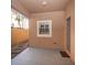 Covered back patio featuring back door access to home and a stone walkway along a wood fence at 409 S Arrawana Ave, Tampa, FL 33609