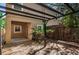Back yard features a wooden deck with a pergola and is surrounded by lush tropical foliage at 409 S Arrawana Ave, Tampa, FL 33609