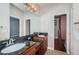 Bathroom with double vanity, granite countertop, and access to a closet space at 409 S Arrawana Ave, Tampa, FL 33609