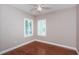 This room features wood floors and window shutters; also includes a ceiling fan at 409 S Arrawana Ave, Tampa, FL 33609