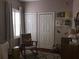Well-lit Bedroom is decorated with calming colors, window shutters, and a rocking chair at 409 S Arrawana Ave, Tampa, FL 33609