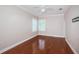 A bedroom featuring sleek hardwood floors, a modern ceiling fan and base molding at 409 S Arrawana Ave, Tampa, FL 33609