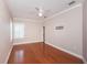 A bedroom featuring sleek hardwood floors, a modern ceiling fan and base molding at 409 S Arrawana Ave, Tampa, FL 33609