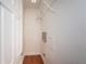 A simple storage closet with light and one shelf on a wood floor at 409 S Arrawana Ave, Tampa, FL 33609