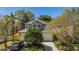 Attractive two-story home featuring a well-maintained lawn, a driveway, and mature trees at 409 S Arrawana Ave, Tampa, FL 33609