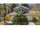 This is an eye-level exterior view that highlights a two-car garage and neatly landscaped front yard at 409 S Arrawana Ave, Tampa, FL 33609