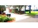 Charming home featuring manicured lawn, complemented by tidy landscaping and private driveway at 409 S Arrawana Ave, Tampa, FL 33609