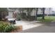 Street view featuring a well-kept lawn, neatly trimmed shrubs, and a paved walkway leading to the house at 409 S Arrawana Ave, Tampa, FL 33609