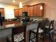 Updated kitchen featuring bar seating, granite countertops, wood cabinets and black appliances at 409 S Arrawana Ave, Tampa, FL 33609