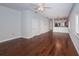 A view of the living room with hardwood floors, a ceiling fan, and access to other living spaces at 409 S Arrawana Ave, Tampa, FL 33609
