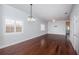 An open-concept living area with wood floors, shutters, crown molding, and a modern ceiling fan at 409 S Arrawana Ave, Tampa, FL 33609