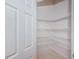 Walk-in pantry featuring metal shelving and a white door at 409 S Arrawana Ave, Tampa, FL 33609
