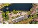 This aerial view highlights the home, pond, and parking area at 4160 Pinelake Ln # 201, Tampa, FL 33618