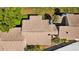 Aerial view of home's brown roof, chimneys, and palm trees at 4160 Pinelake Ln # 201, Tampa, FL 33618