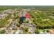 An aerial view of the neighborhood with a pond and mature trees at 4160 Pinelake Ln # 201, Tampa, FL 33618