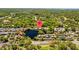A picturesque aerial view of the home and neighborhood pond at 4160 Pinelake Ln # 201, Tampa, FL 33618