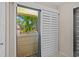 Cozy balcony with sliding glass door, offering a view of the peaceful pond and lush trees at 4160 Pinelake Ln # 201, Tampa, FL 33618