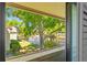 Balcony view showcasing a tranquil pond with a fountain, surrounded by lush greenery at 4160 Pinelake Ln # 201, Tampa, FL 33618